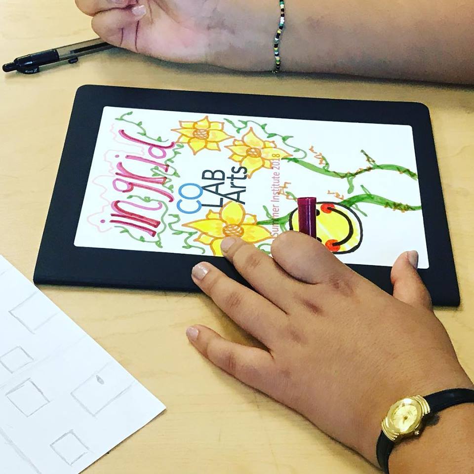 Person drawing on a tablet.