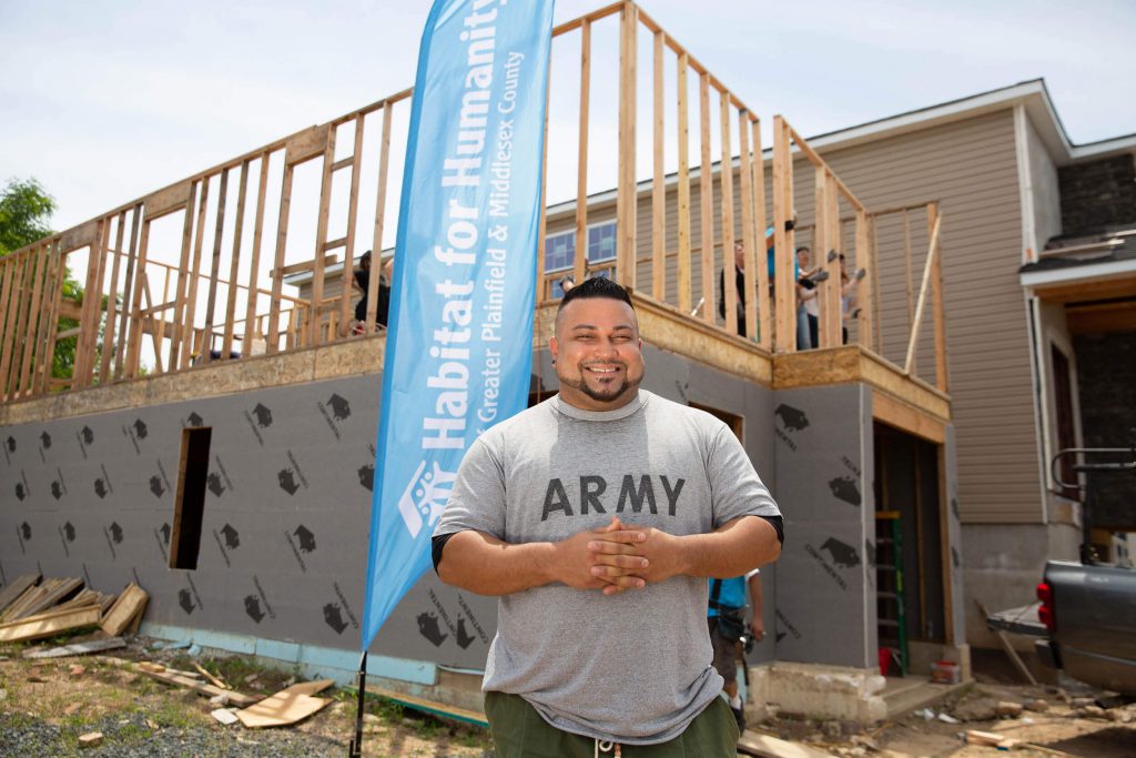 Habitat for Humanity worker standing in front a construction project.